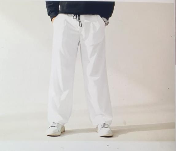 Fashion model wearing a modern black shirt and relaxed premium trousers